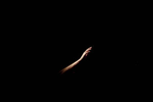 Hand reaching from darkness